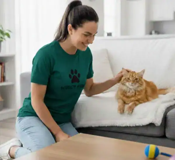 Professional pet grooming service with a groomer and a relaxed cat at Muddy Paws.